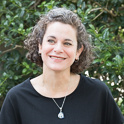 a smiling woman looking off camera