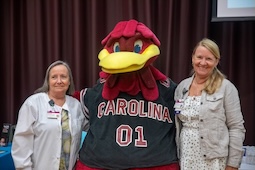 Vendors posing with Cocky