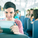 boy looking at ipad on bus