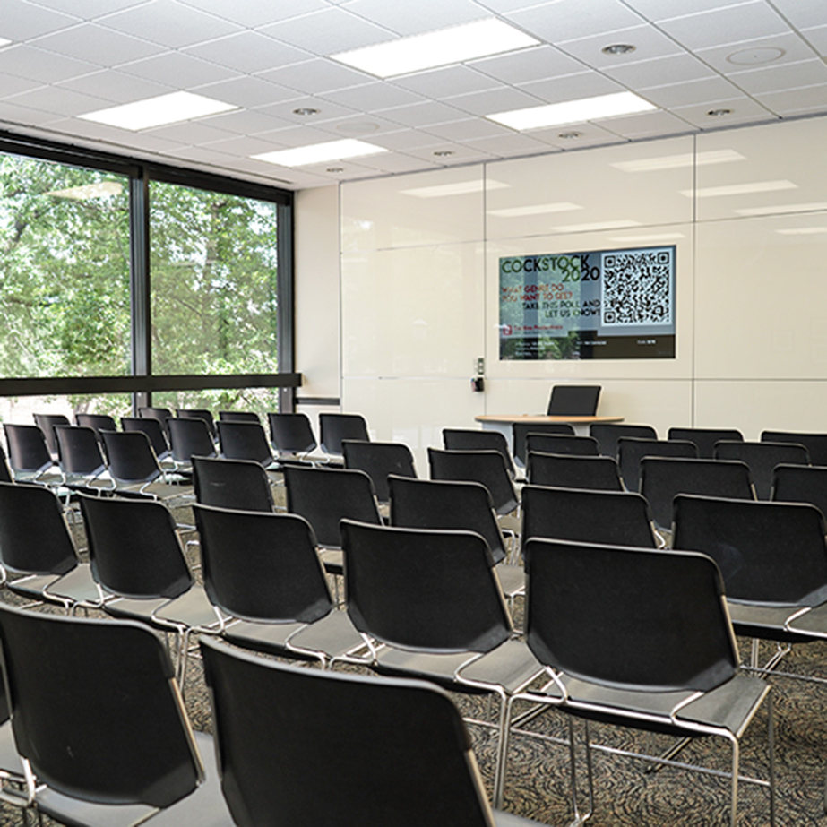 A classroom set up with rows of chairs.