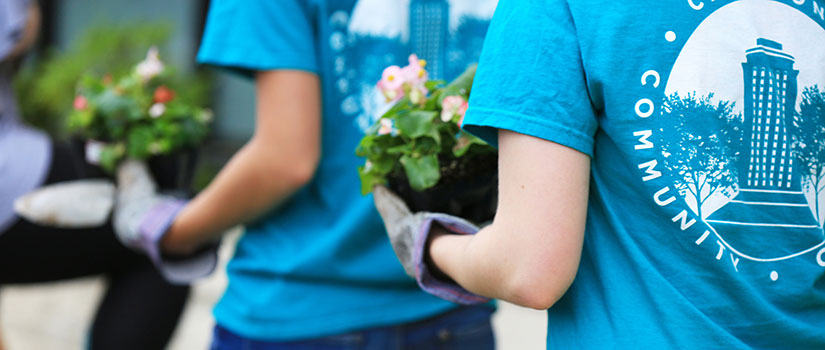 students tend a local garden during Service Saturday