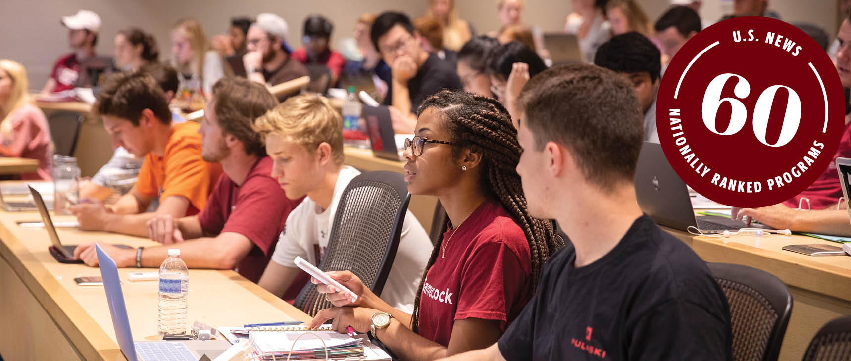 Students in a classroom with a stamp stating USC has 60 nationally ranked programs.