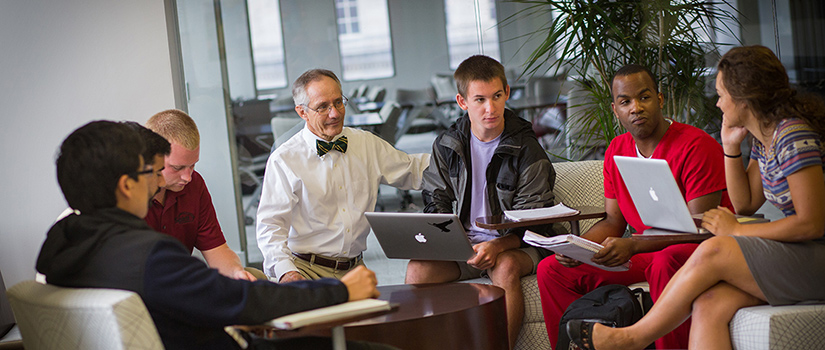 a faculty member works with a group of students