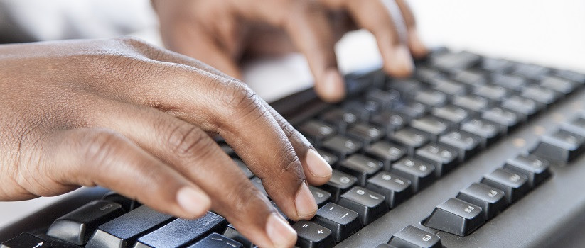 Close-up of fingers typing on keyboard