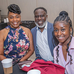 three alumni smiling