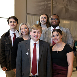 young alumni pose together at the SC Statehouse on Carolina Day