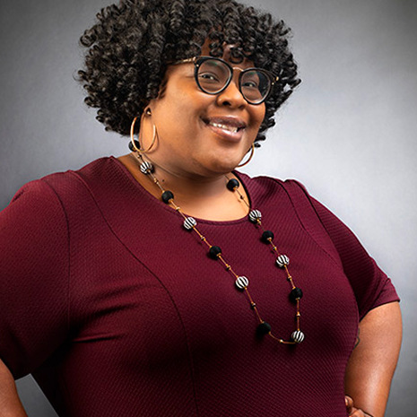 woman with garnet sweater on smiling