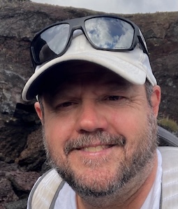 Headshot of John Kupfer out in the field