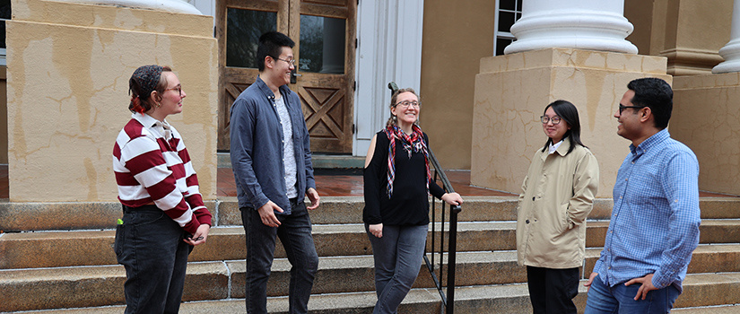 Graduate students standing outside Davis College