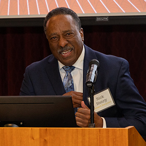 Rick Henry standing at a microphone