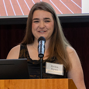 Erika Ryan speaking at the podium