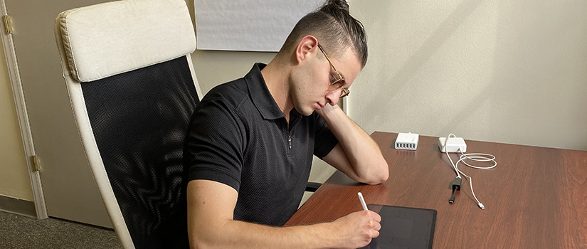 Jonah Rotholz sits at a desk