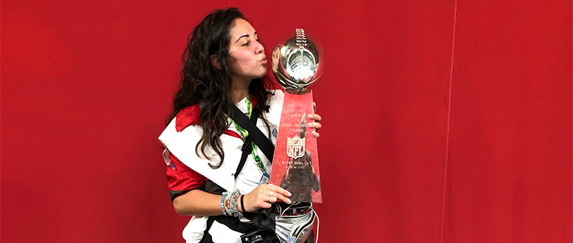 Tori Richmand holding the Super Bowl trophy