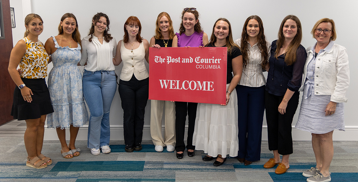 Post and Courier interns holding a Welcome Sign