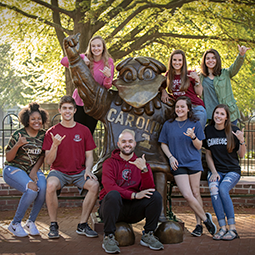 Students in front of cocky statue