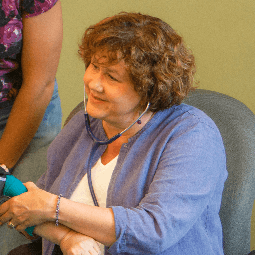 Woman taking a patients blood pressure