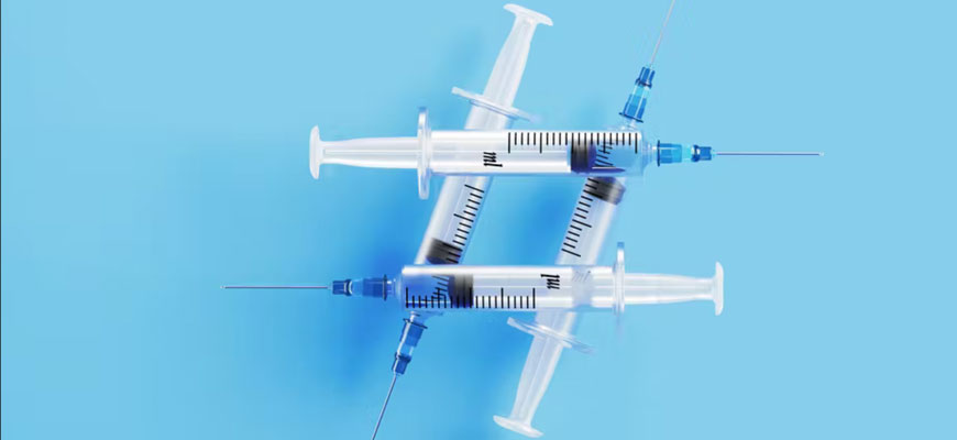 Syringes forming a hashtag symbol on a blue background