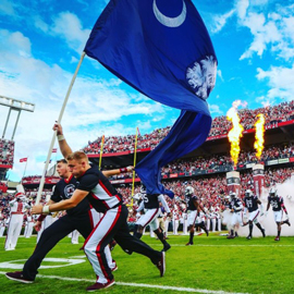 Football team is led in with the South Carolina state flag