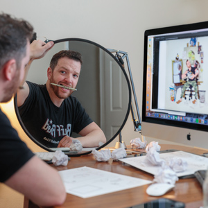 artist kev roche is photographed from behind looking in a mirror