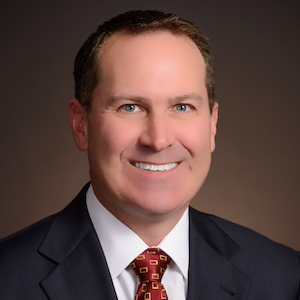 man in suit smiles at camera