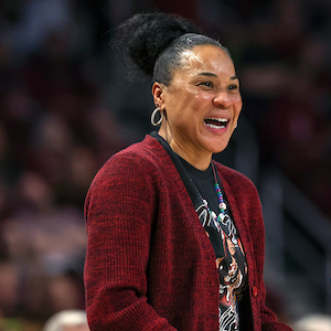 woman with black hair wearing garnet cardigan smiling