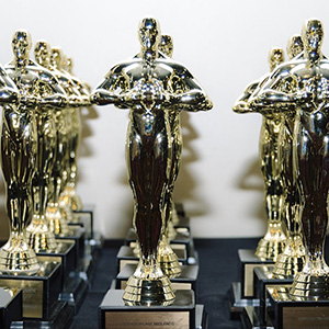 Closeup of rows of golden Oscar-esque statuettes 