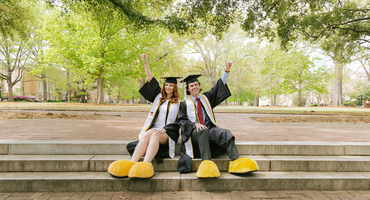 Walker Weaver and Emma Connelly pose on the Horseshoe wearing their yellow Cocky feet.