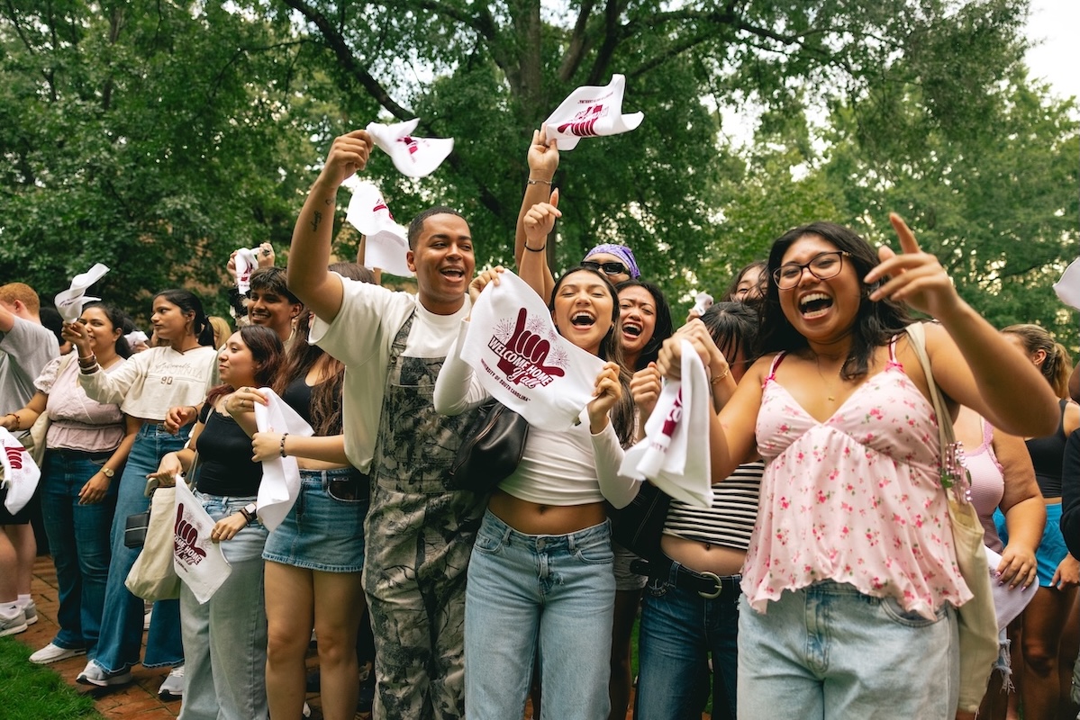 Group of students swing towels around and participating in sandstorm