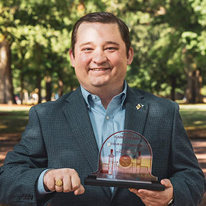 Colin Hungerpiller stands on USC Horseshoe holding award