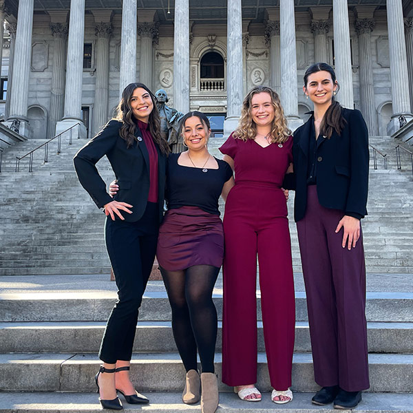 Blakely Hardin and her student government team stand otuside the statehouse