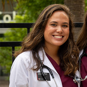 Lauren Larosa in white coat with stethascope.